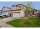 Two-story home with a manicured lawn and driveway leading to an attached two-car garage at 5039 Fontana Ct, Denver, CO 80239