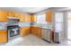 A shot of the kitchen featuring stainless steel appliances, and wood-stained cabinets at 5039 Fontana Ct, Denver, CO 80239