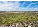 Scenic aerial view showcases a lush golf course surrounded by residential homes and mature trees under a bright sky at 4062 S Atchison Way # 302, Aurora, CO 80014