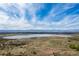 Aerial view of a lake, mountains, and city skyline in the background at 4062 S Atchison Way # 302, Aurora, CO 80014