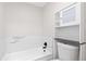 Bright bathroom featuring a tub with tiled walls and updated fixtures providing a clean, modern aesthetic at 4062 S Atchison Way # 302, Aurora, CO 80014