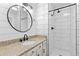 Modern bathroom with a sleek subway tile shower, granite countertop, and a stylish round mirror for a fresh aesthetic at 4062 S Atchison Way # 302, Aurora, CO 80014