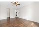 Bedroom with hardwood floors, neutral paint, ceiling fan, and doorway to laundry and walk-in closet at 4062 S Atchison Way # 302, Aurora, CO 80014