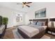 Spacious bedroom boasts a large bed, wood floors, contemporary decor, and a window with a view at 4062 S Atchison Way # 302, Aurora, CO 80014