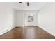 Bright bedroom featuring hardwood floors, white walls, and a ceiling fan for comfortable living at 4062 S Atchison Way # 302, Aurora, CO 80014
