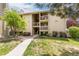Tan two-story condo building with balconies and landscaping at 4062 S Atchison Way # 302, Aurora, CO 80014