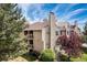 Exterior view of a multi-story building with balconies, a chimney, and mature trees at 4062 S Atchison Way # 302, Aurora, CO 80014