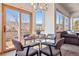 Breakfast nook features a glass table, chairs, and access to a beautiful deck and mountain views at 8493 S Newcombe Way, Littleton, CO 80127