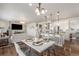 Open-concept living room featuring a dining area, modern lighting, and seamless access to the kitchen at 4665 W 108Th Ct, Westminster, CO 80031