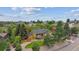 An aerial view showcases this beautiful home surrounded by lush greenery and a serene neighborhood at 8966 Sunridge Hollow Rd, Parker, CO 80134