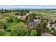Aerial shot of the property featuring mature trees, a deck, and neighborhood views with picturesque mountain scenery at 8966 Sunridge Hollow Rd, Parker, CO 80134