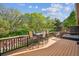 Spacious back deck with dining table, hot tub, and views of the lush, green backyard at 8966 Sunridge Hollow Rd, Parker, CO 80134