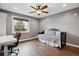 Cozy bedroom with a daybed, a dark ceiling fan, hardwood floors, and lots of natural light at 8966 Sunridge Hollow Rd, Parker, CO 80134