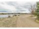 Scenic view of a community lake with walking trails, shrubbery and residential neighborhood in the distance at 8966 Sunridge Hollow Rd, Parker, CO 80134