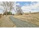A gravel walking path leads into a community park with playground equipment and mature trees in the background at 8966 Sunridge Hollow Rd, Parker, CO 80134
