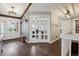 Elegant entryway featuring hardwood floors, a coat rack, and French doors leading to other rooms at 8966 Sunridge Hollow Rd, Parker, CO 80134