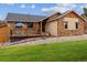 Charming home features a stone and wood facade, a deck, and a well-manicured lawn at 8966 Sunridge Hollow Rd, Parker, CO 80134
