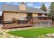Exterior view of a home with a spacious deck, hot tub, and well-maintained yard for relaxation and entertainment at 8966 Sunridge Hollow Rd, Parker, CO 80134