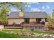 Rear exterior view showcasing a large deck with seating, a hot tub, and a landscaped yard, great for outdoor living at 8966 Sunridge Hollow Rd, Parker, CO 80134