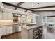 Well-appointed kitchen featuring stainless appliances, a kitchen island with seating, and hardwood floors at 8966 Sunridge Hollow Rd, Parker, CO 80134