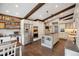 Bright kitchen with stainless steel appliances, white cabinetry, wooden beams, and a center island at 8966 Sunridge Hollow Rd, Parker, CO 80134