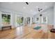 Bright and airy living room with hardwood floors, high ceilings, and large sliding glass doors at 8966 Sunridge Hollow Rd, Parker, CO 80134