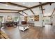 Spacious open-concept living and dining area featuring wood floors and exposed beams at 8966 Sunridge Hollow Rd, Parker, CO 80134