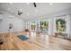 Bright and airy living room with hardwood floors, high ceilings, and large sliding glass doors at 8966 Sunridge Hollow Rd, Parker, CO 80134