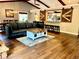 Open living space with hardwood floors, barn door accents, and access to the kitchen bar at 8966 Sunridge Hollow Rd, Parker, CO 80134