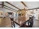 Bright living and dining area with hardwood floors, exposed beams, and a stone fireplace at 8966 Sunridge Hollow Rd, Parker, CO 80134