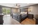 Spacious bedroom features a sliding glass door to a deck and an ornate wooden bed frame at 8966 Sunridge Hollow Rd, Parker, CO 80134
