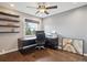 Office space with a window view, dark hardwood flooring, floating shelves, and a modern desk at 8966 Sunridge Hollow Rd, Parker, CO 80134