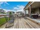 Expansive backyard featuring lush green grass, mature trees, and a large wooden deck with outdoor seating at 4555 Gray Wolf Ln, Castle Rock, CO 80104