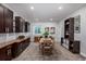 Open dining area with dark cabinets, wood countertop, and space for entertaining at 4555 Gray Wolf Ln, Castle Rock, CO 80104