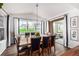Elegant dining room with large table, hardwood floors, and natural light from the expansive windows at 4555 Gray Wolf Ln, Castle Rock, CO 80104