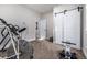 Bright room features exercise equipment, modern lighting, and barn door closet at 4555 Gray Wolf Ln, Castle Rock, CO 80104