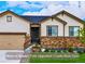 Charming single-Gathering home with a stone facade, manicured lawn, and an attached two-car garage at 4555 Gray Wolf Ln, Castle Rock, CO 80104