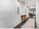 Elegant hallway with paneled walls, a wooden bench, and a patterned rug offers a welcoming entrance at 4555 Gray Wolf Ln, Castle Rock, CO 80104