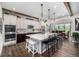 Spacious kitchen with an island, stainless appliances, white cabinets and room for dining at 4555 Gray Wolf Ln, Castle Rock, CO 80104