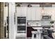 Close up view of the stainless steel appliances, tile back splash and cabinets in this updated kitchen at 4555 Gray Wolf Ln, Castle Rock, CO 80104