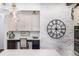 Bright kitchen with a white brick accent wall, modern lighting, and stylish cabinets offers a blend of charm and function at 4555 Gray Wolf Ln, Castle Rock, CO 80104