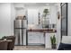 Efficient kitchenette featuring white cabinets, wood counters, and stainless steel appliances at 4555 Gray Wolf Ln, Castle Rock, CO 80104