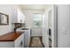 Well-organized laundry room featuring sleek white cabinetry, a wood countertop, and modern appliances at 4555 Gray Wolf Ln, Castle Rock, CO 80104