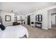 Spacious living area with a kitchen, cozy sitting area, and a sliding barn door at 4555 Gray Wolf Ln, Castle Rock, CO 80104