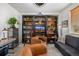 Cozy living room featuring a large bookcase with ladder, comfortable seating, and stylish decor, perfect for relaxation at 4555 Gray Wolf Ln, Castle Rock, CO 80104