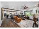Open-concept living room with dark wood floors seamlessly connecting to the kitchen and dining area at 4555 Gray Wolf Ln, Castle Rock, CO 80104