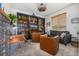Inviting living room features a floor-to-ceiling bookcase, sofa, armchairs and a window creating a comfortable space at 4555 Gray Wolf Ln, Castle Rock, CO 80104
