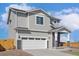 Beautiful two-story home featuring neutral siding, a two-car garage, and a welcoming front porch with stone accents at 17962 E 94Th Pl, Commerce City, CO 80022