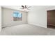 Spacious main bedroom with plush carpet, ceiling fan, and generous closet space at 17962 E 94Th Pl, Commerce City, CO 80022