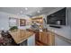 Stylish finished basement bar featuring granite counters, wood cabinetry, and seating at 4586 Best Rd, Larkspur, CO 80118